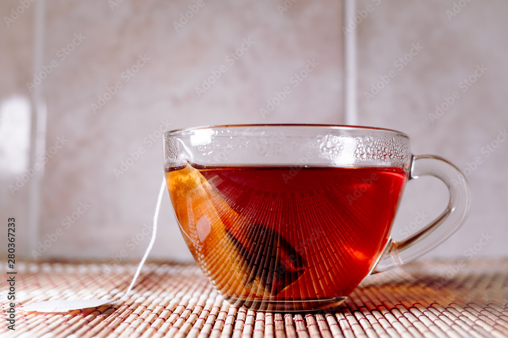 Fototapeta premium tea in a clear glass black