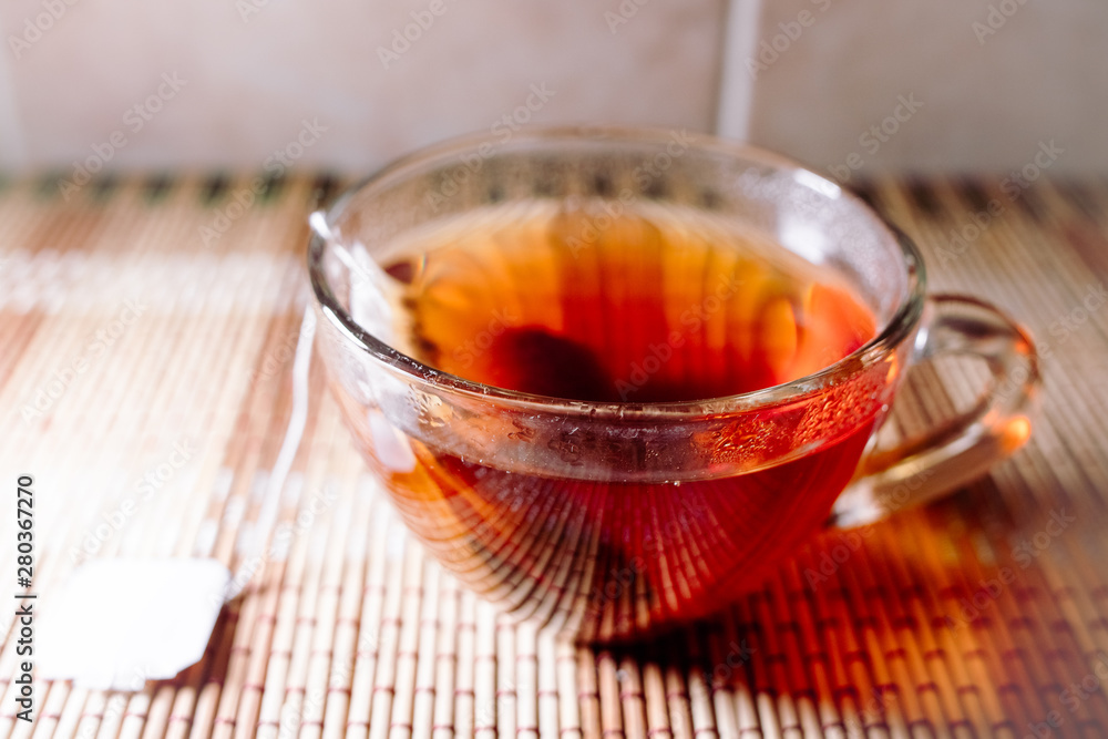 Fototapeta premium tea in a clear glass black