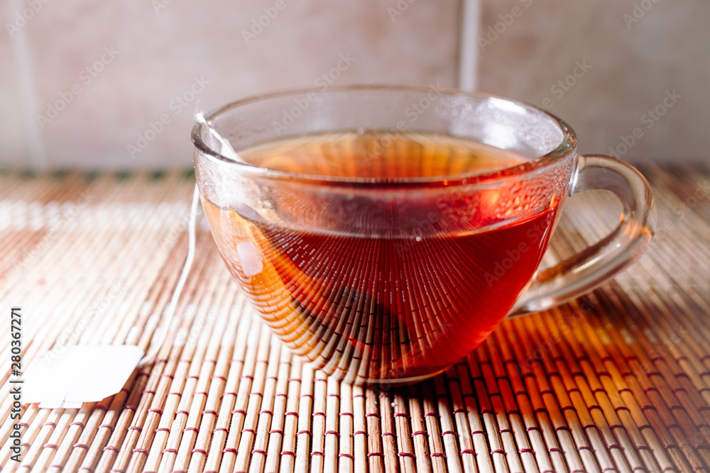 Fototapeta premium tea in a clear glass black
