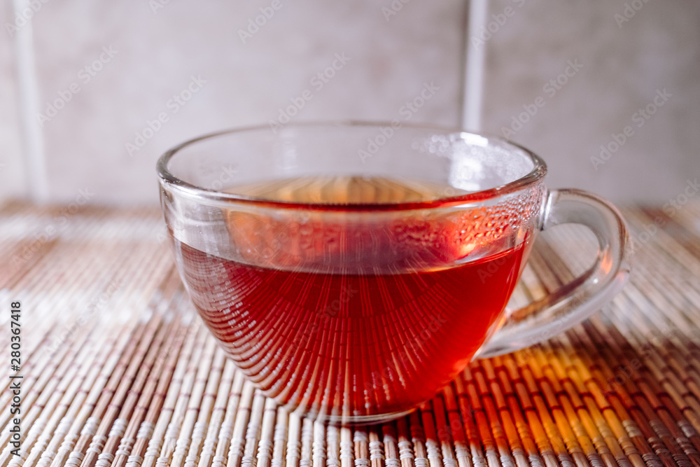Fototapeta premium tea in a clear glass black