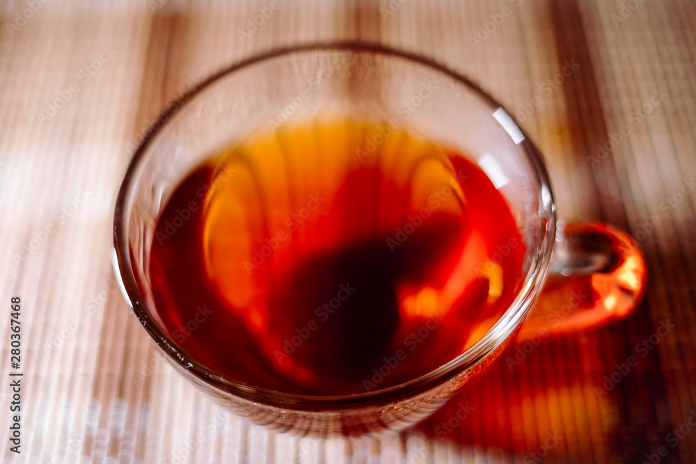 Fototapeta premium tea in a clear glass black