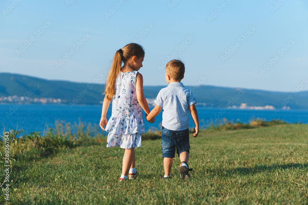 brother and sister walking away brother and sister walking away