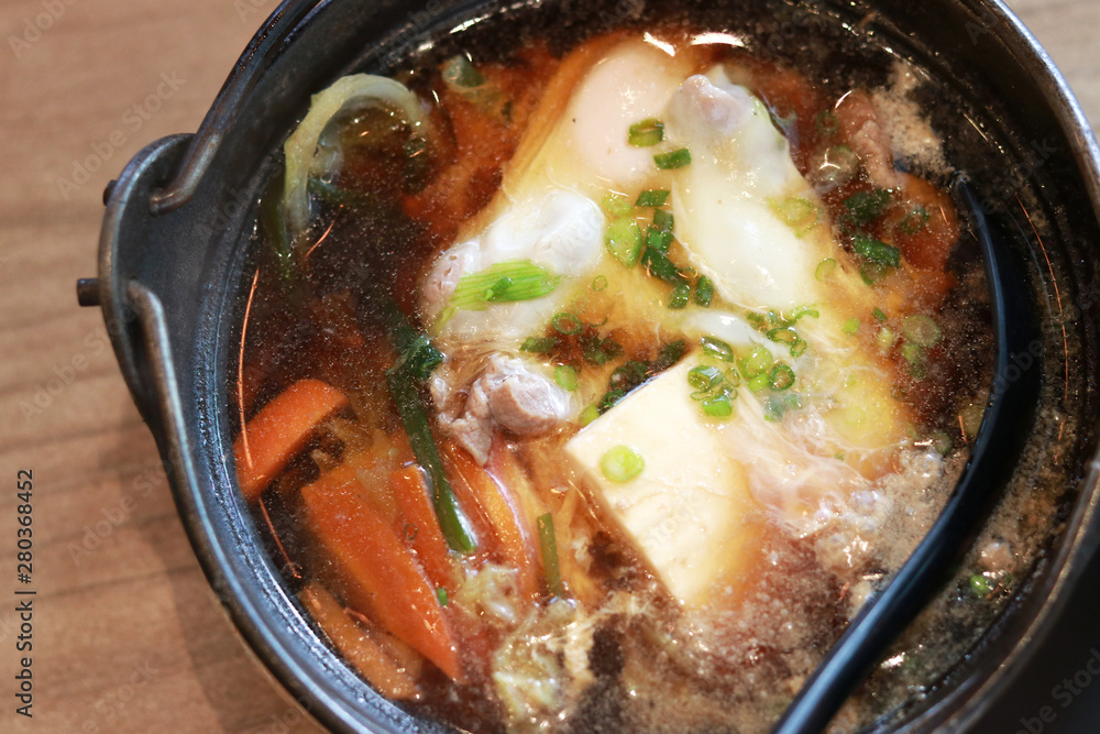 Sukiyaki served in hot pot in Japanese restaurant Sukiyaki served in hot pot in Japanese restaurant