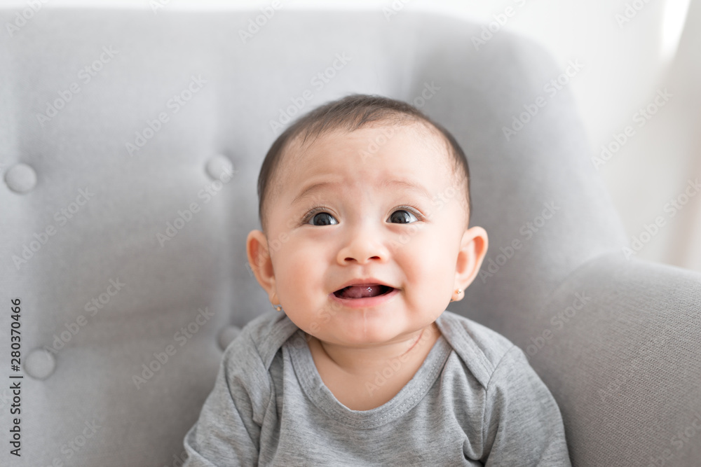 Cute little baby playing at home in gray room Cute little baby playing at home in gray room