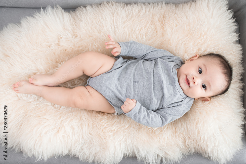 cute happy baby portrait lying on fur