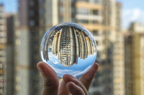 round Glass ball with big city buildings background