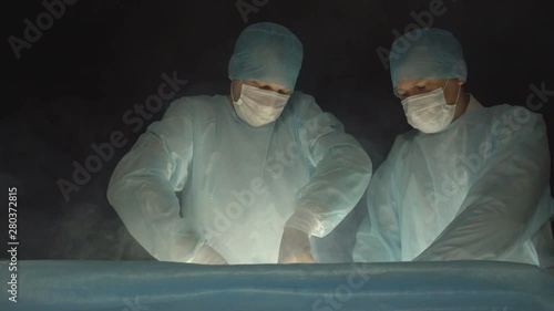 Two surgeon doctors perform an operation using a modern method and treatment with liquid nitrogen and cryotherapy, ozone therapy photo