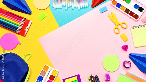 School supplies and lunchbox with food for kids. Colorful stationery layout on multicolor background, copy space