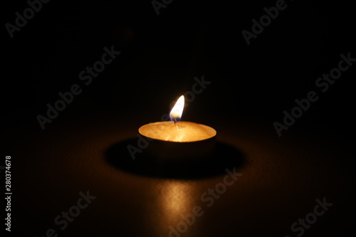 burning candle tablet in the dark