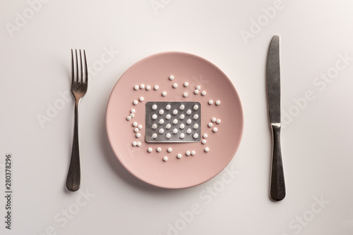 Blister with pills on the plate. Flat lay.