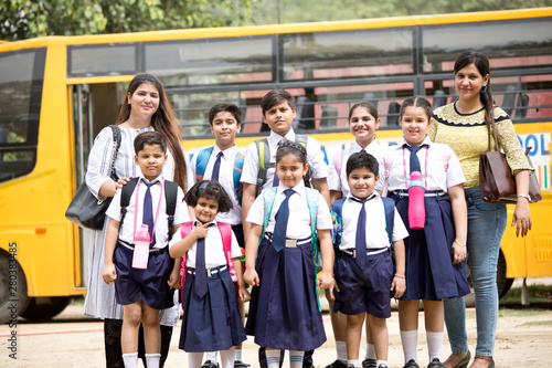 Group of school children with teachers standing in group
