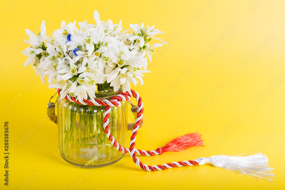 Spring time flowers like snowdrops, hyacinth and roses, isolated on yellow simple background, spring symbol and traditional romanian 