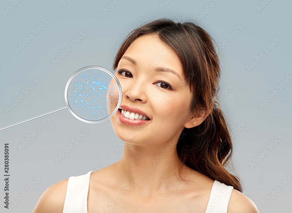 beauty, technology and skin care concept - face of happy smiling young asian woman with low poly shape projection in pointer beauty, technology and skin care concept - face of happy smiling young asian woman with low poly shape projection in pointer