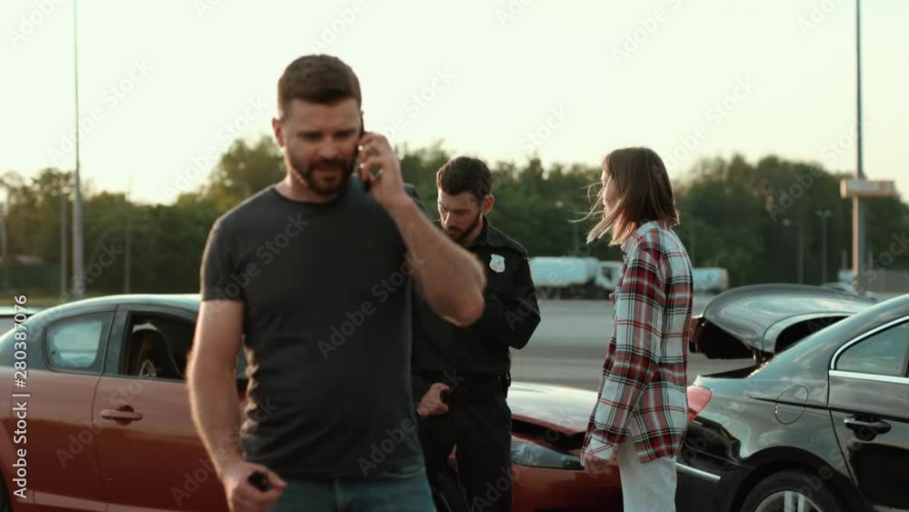 Portrait of baffled man calling his wife talking on smartphone outdoors. Driver asking for help speaking by cellphone against a car crash. Policeman and female driver girl talking and arguing. Portrait of baffled man calling his wife talking on smartphone outdoors. Driver asking for help speaking by cellphone against a car crash. Policeman and female driver girl talking and arguing.