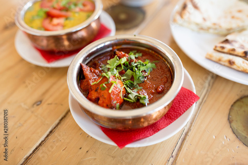 food, south asian cuisine, culinary and cooking concept - close up of kidney bean masala in bowl on table of indian restaurant