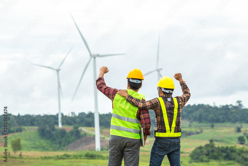 Two Windmill engineer inspection and progress check wind turbine at construction site And succeeded in the mission. Two Windmill engineer inspection and progress check wind turbine at construction site And succeeded in the mission.