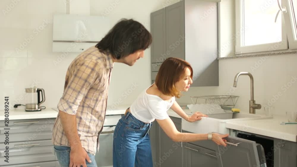 Mature couple is inspecting a new kitchen in their home. Buying real estate concept Mature couple is inspecting a new kitchen in their home. Buying real estate concept