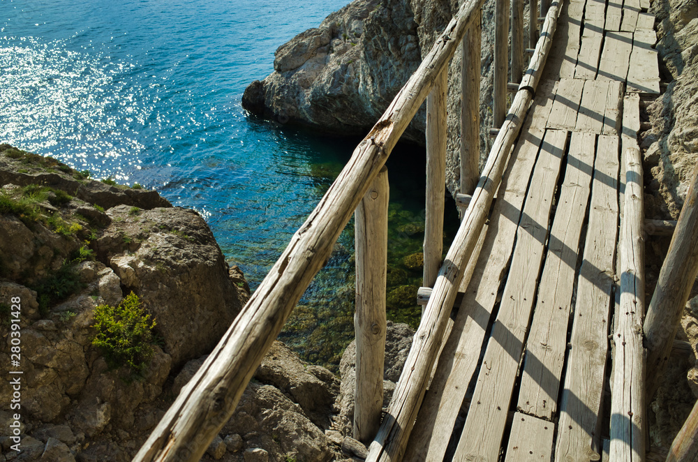 Wooden bridge along the mountain path near the Black Sea. Cape Alchak, Republic of Crimea