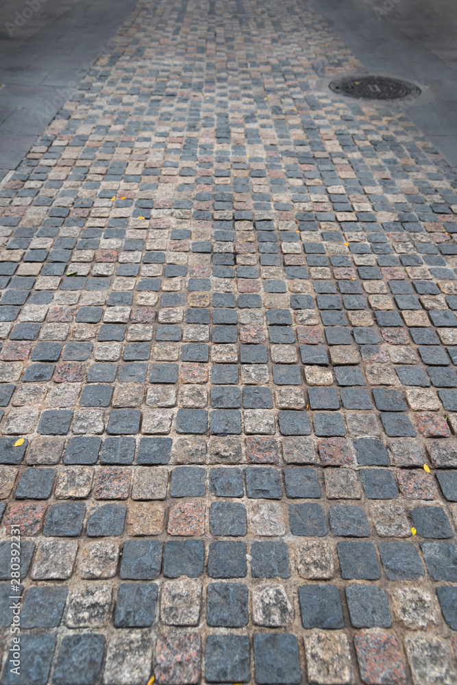 Fototapeta premium road paved stones of a Brick Walkway, background and pattern