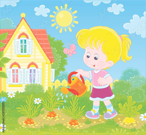 Smiling little girl waterin...