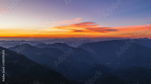 Golden and blue sky of a sunrise over mountains
