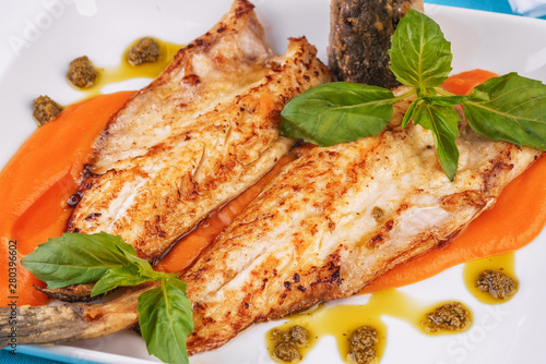  Sea fish steak with basil and green pepper on a pumpkin puree pillow according to the Georgian recipe. Mediterranean cuisine