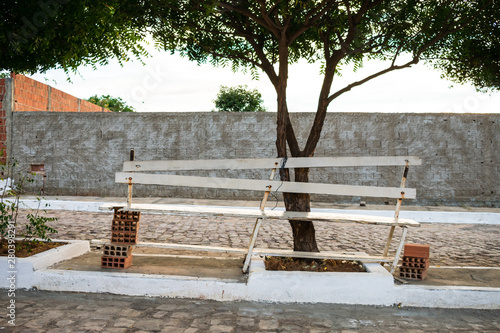 Fényképezés Poorly built wooden bench supported by bricks on a street in Oeiras, Piaui - Bra
