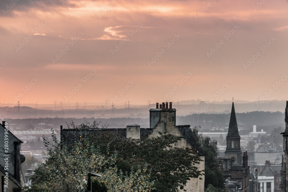 View over the roofs of houses in scotland during sunset.