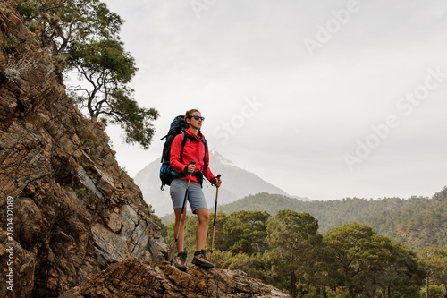 Female traveller hiking on hills on coast photo