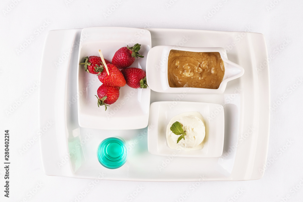 vanilla ice cream fondue, milk chocolate, and strawberries on skewers vanilla ice cream fondue, milk chocolate, and strawberries on skewers