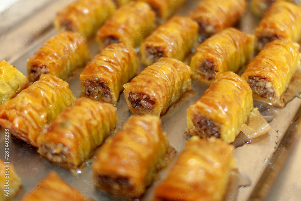 Pieces of baklava, traditional sweet dessert pastry made of layers of filo filled with chopped nuts and syrup Pieces of baklava, traditional sweet dessert pastry made of layers of filo filled with chopped nuts and syrup