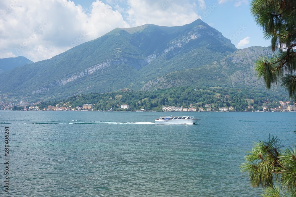 Sailing boat on Lake Como. View from the shore. Sailing boat on Lake Como. View from the shore.