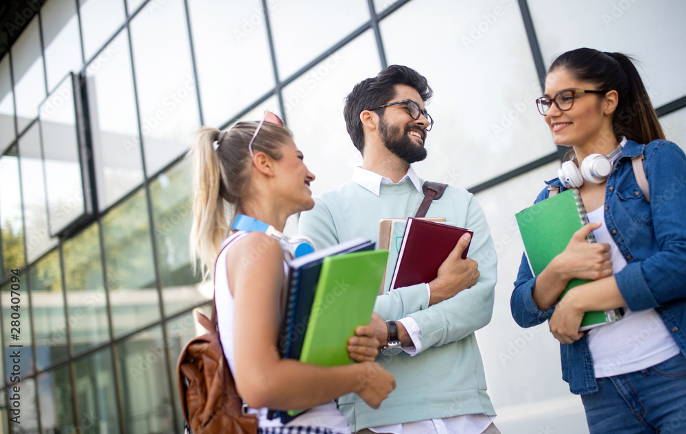 Happy young university students studying together. Group of multiracial friends in college Happy young university students studying together. Group of multiracial friends in college