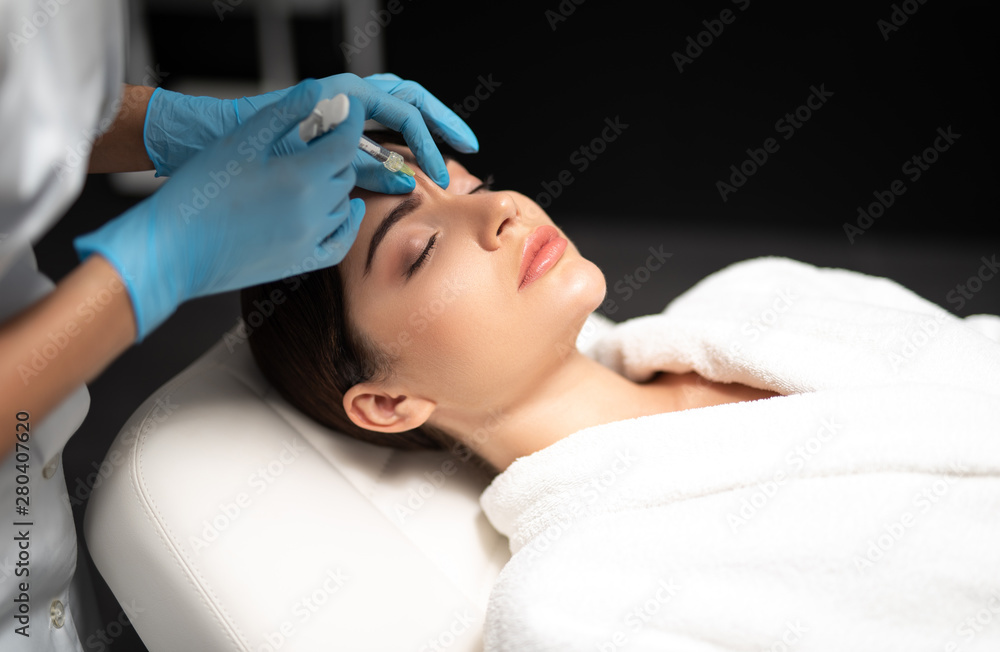 Young woman getting beauty injections at spa salon Young woman getting beauty injections at spa salon