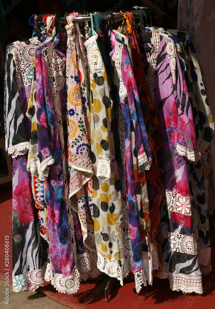 Indian street vendor display clothes,dress and accessories hung on hangers in outdoors in market Indian street vendor display clothes,dress and accessories hung on hangers in outdoors in market