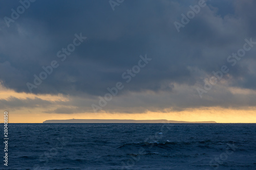 Lundy Island at sunset with stormy sky © David A