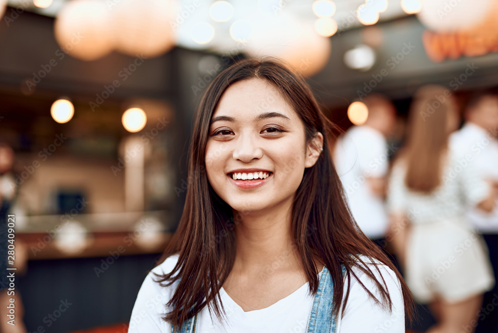 Pretty smiling asian lady on city view Pretty smiling asian lady on city view