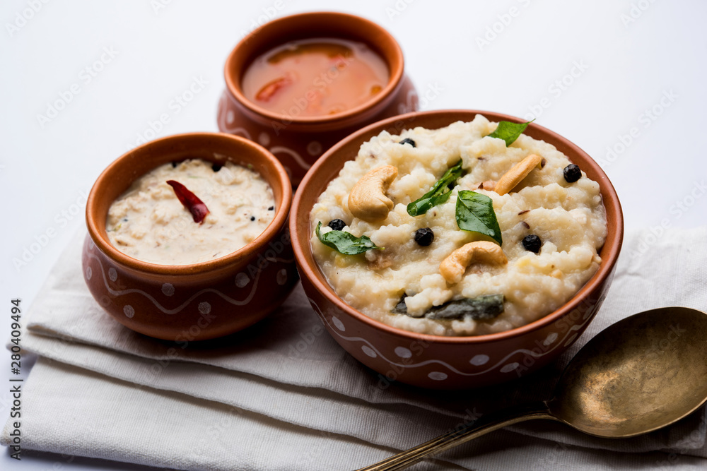 Ven pongal recipe is a popular South Indian food prepared with rice & moong dal and served with sambar and coconut chutney, selective focus Ven pongal recipe is a popular South Indian food prepared with rice & moong dal and served with sambar and coconut chutney, selective focus