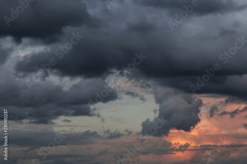 Stormy skies at sunset. Dark dramatic storm clouds