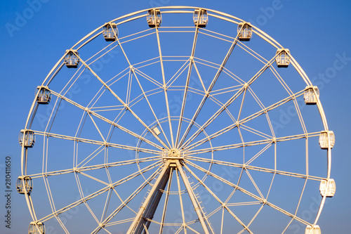 Ferris wheel in summer in the blue sky