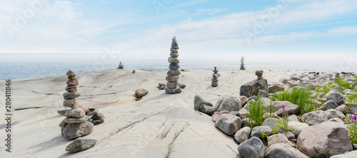 Stacked Rocks balancing, stacking with precision. Stone tower on shore. Copy space.