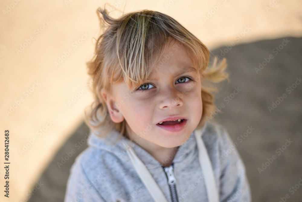 Blond kid walking on the beach in light clothes. Cold summer day. A lonely boy on the river Bank. Emotions. Suffering, unhappiness, sadness, sadness, tears, pain, loss. Blond kid walking on the beach in light clothes. Cold summer day. A lonely boy on the river Bank. Emotions. Suffering, unhappiness, sadness, sadness, tears, pain, loss.