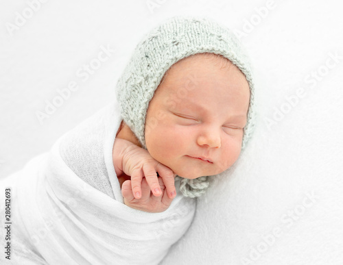 Newborn boy wrapped in a blanket