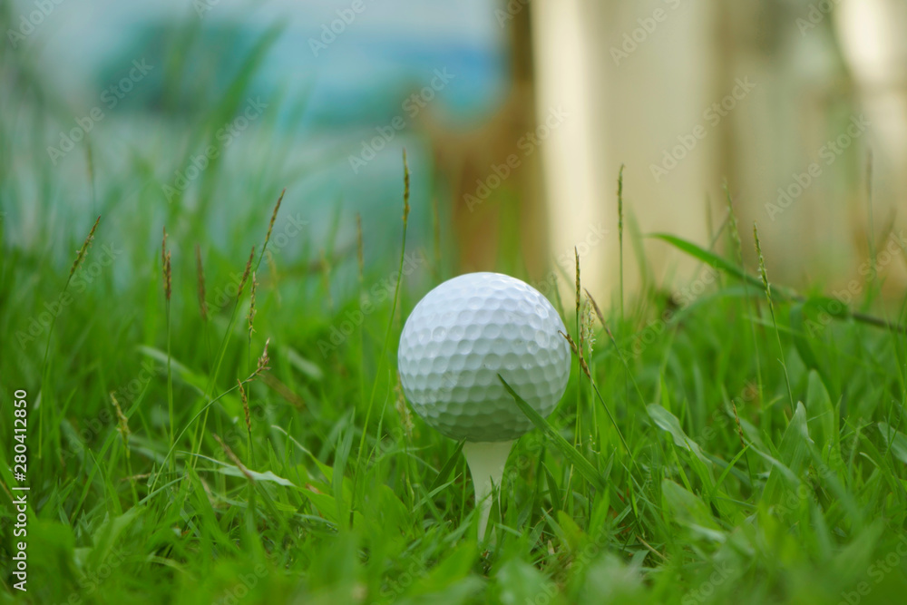 Golf ball on tee in beautiful golf course at sunset background. Golf ball on tee in beautiful golf course at sunset background.