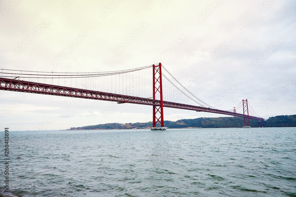 Naklejka premium The 25 April bridge (Ponte 25 de Abril) is a steel suspension bridge located in Lisbon, Portugal, crossing the Targus river. It is one of the most famous landmarks of the region.