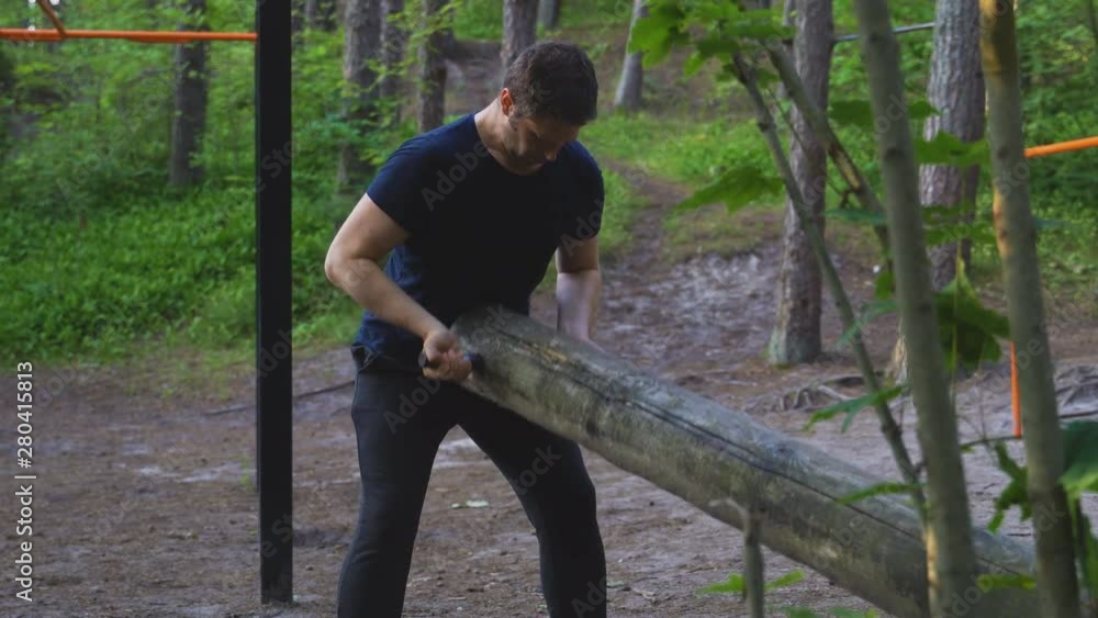 Man lifting log in the forest. Sports concept. Man lifting log in the forest. Sports concept.