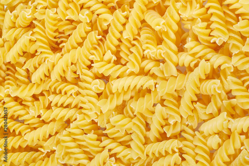 Background of pasta in a spiral of yellow color. Background of pasta in a spiral of yellow color.