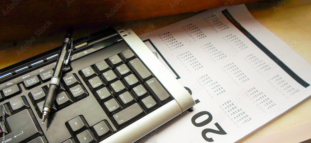 keyboard, pen and calendar on the table. workplace keyboard, pen and calendar on the table. workplace