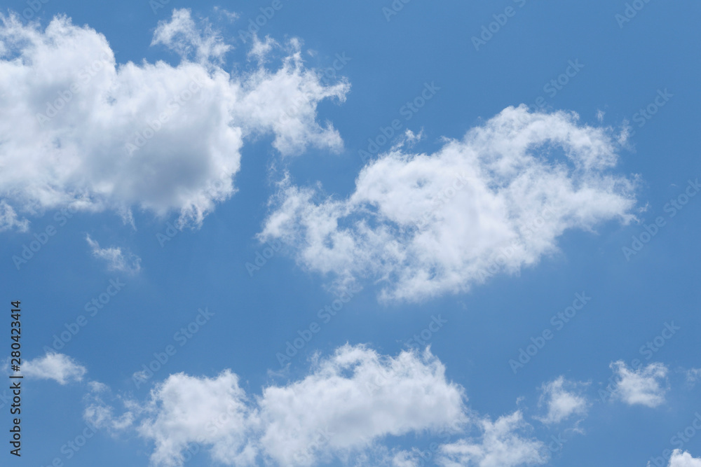 Blue sky background with white clouds. Cropped shot, horizontal, free space. Concept of natural beauty. Blue sky background with white clouds. Cropped shot, horizontal, free space. Concept of natural beauty.