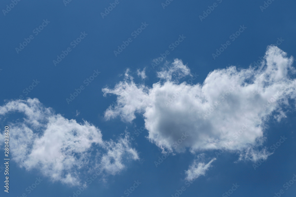 Blue sky background with white clouds. Cropped shot, horizontal, free space. Concept of natural beauty. Blue sky background with white clouds. Cropped shot, horizontal, free space. Concept of natural beauty.